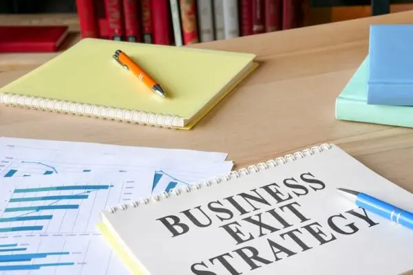 A desk with paperwork for a business exit strategy