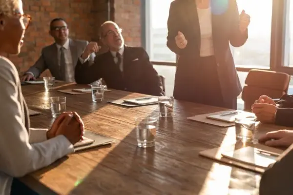 A full conference room during a leadership meeting