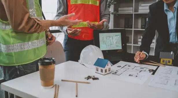 Contractors planning a new business expansion with blueprints