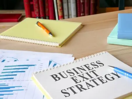 A desk with paperwork for a business exit strategy