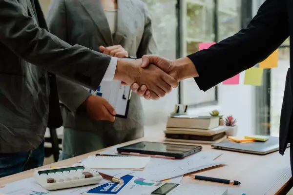 Business leaders shaking hands to close a deal
