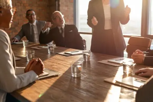 A full conference room during a leadership meeting